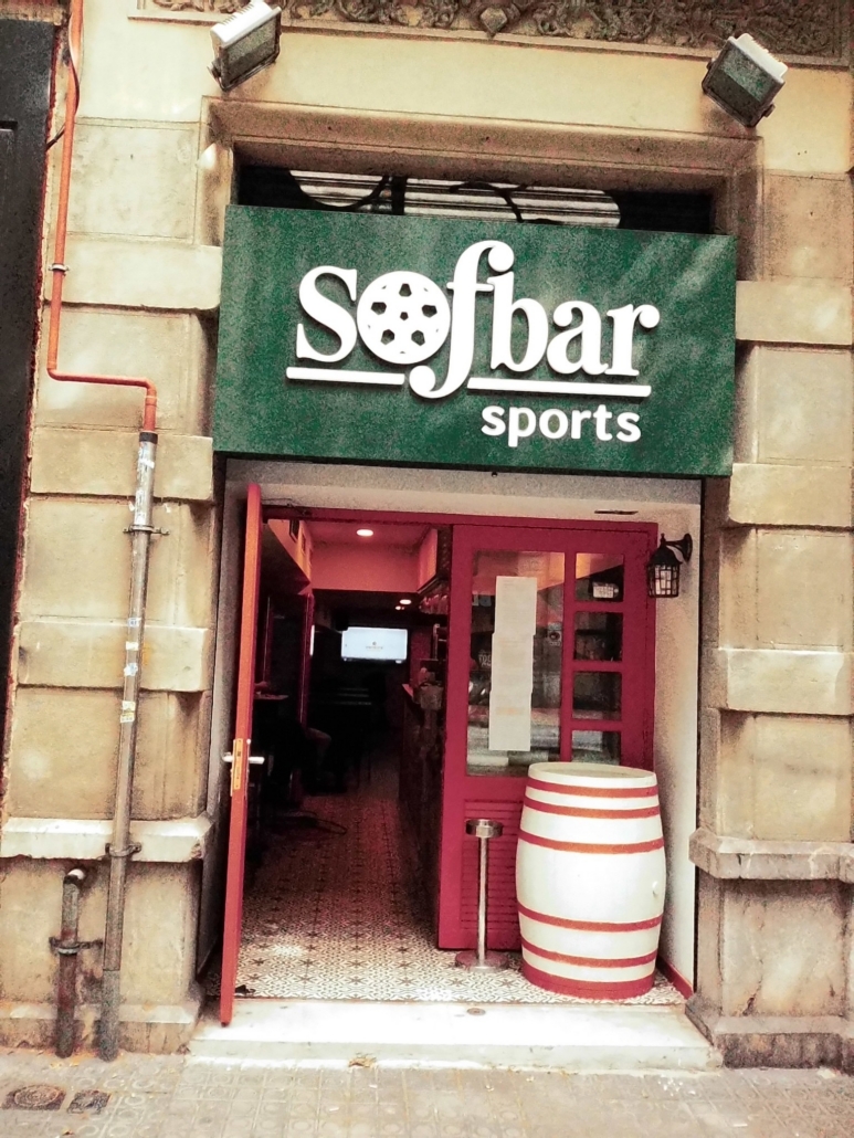 Block - Mountian - 11 of 13 - Petsolt Family Entrance to a sports bar with a green sign reading 'Sofbar sports' and a soccer-ball motif in the O