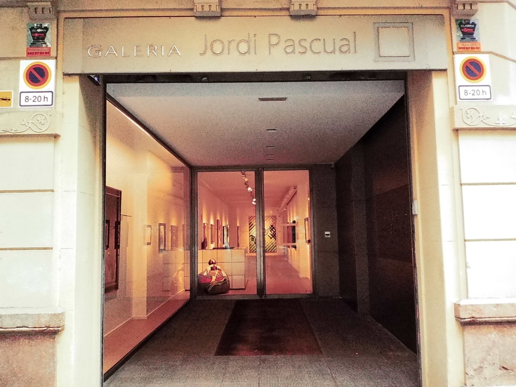 Block - Right - 4 of 4 - Petsolt Family Gallery entrance with glass doors and a sign reading 'GALERIA Jordi Pascual' above the entry, interior art visible along the walls inside.
