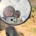 Person wearing helmet and sunglasses reflected in a round mirror, smiling at the camera outdoors, making a peace sign with fingers