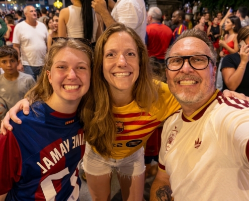 Reduce noise make faces clearer - Petsolt Family - Petsolt Family Three friends take a selfie in a crowded street crowd, all smiling and wearing colorful sports jerseys.